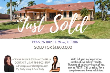 Stunning mansion exterior surrounded by palm trees, showcasing a tropical paradise setting.